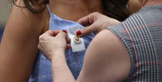 A nursing graduate receiving her pin